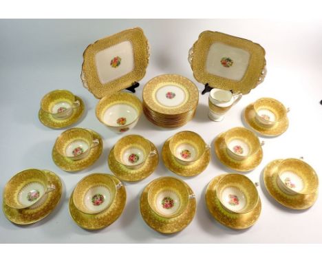 A George Jones Crescent yellow and gold tea service comprising twelve plates, eleven cups and saucers, milk jug, sugar bowl a