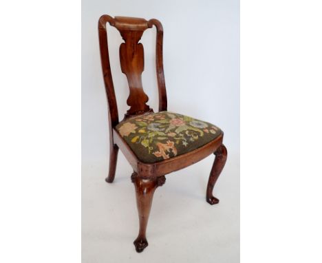 A George I walnut chair with vase shaped splat and drop in woolwork tapestry seat, all raised on cabriole supports with flora