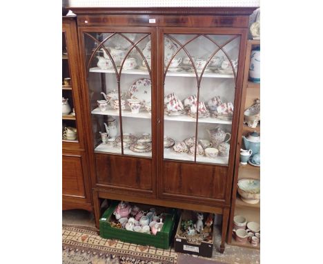 An Edwardian mahogany display cabinet with a pair of pointed arch glazed doors on slender supports, 116 x 40 x 179cm, one gla