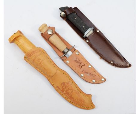 J. Marttiini, Finland, a wooden handled knife, signed 11cm blade, scabbard and two other knives 