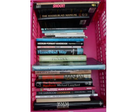 Two boxes of photography books and camera manuals to include titles such as The Hasselblad Manual, The Darkroom Handbook and 