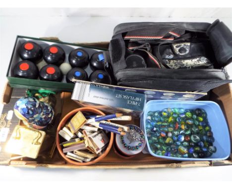 A good mixed lot to include a set of carpet bowls, a mantel clock, seven piece hip flask set, vintage marbles, vintage camera