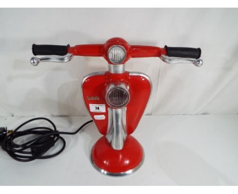 A red lamp in the form of a Lambretta scooter, approximately 17 cm (h) - This lot MUST be paid for and collected, or delivery