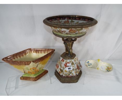 A ceramic and brass centrepiece with a floral decoration, makers mark to the base, approx. height 37 cm, overall diameter 28.