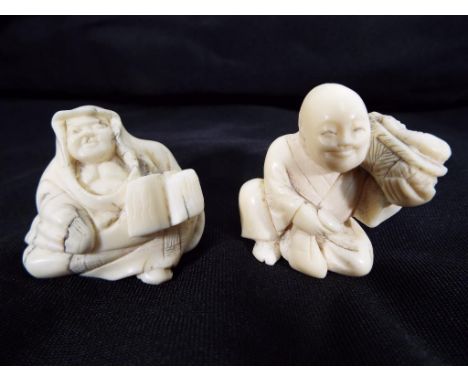 Two late 19th century ivory netsuke one in the form of a seated man holding a basket of fish and the other a seated man holdi