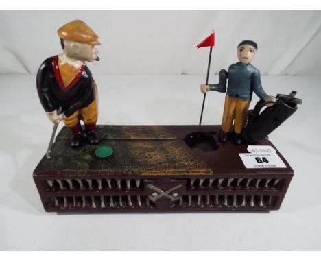 A cast iron mechanical money bank in the form of a golfer and a caddy - This lot MUST be paid for and collected, or delivery 