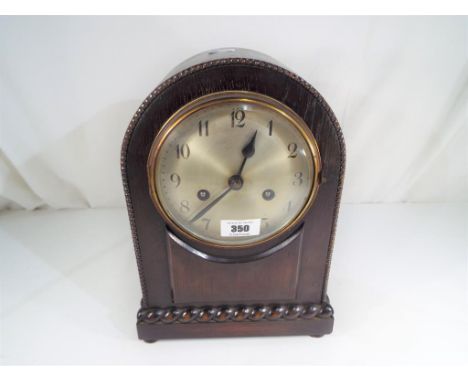 An oak cased mantel clock, Arabic numerals on a silvered dial, striking on the hour and half hour  - This lot MUST be paid fo