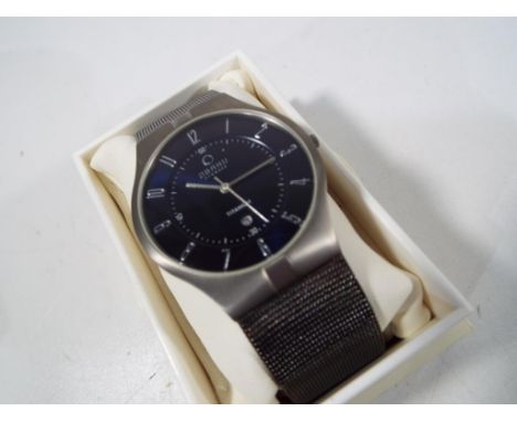 A gentleman's Obaku, Denmark, titanium cased wristwatch on a woven/ close-link titanium bracelet, black dial with centre seco