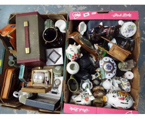 Two boxes containing a good mixed lot to include a Rolls Royce razor, a Remington vintage shaver, an early oak cased trinket 