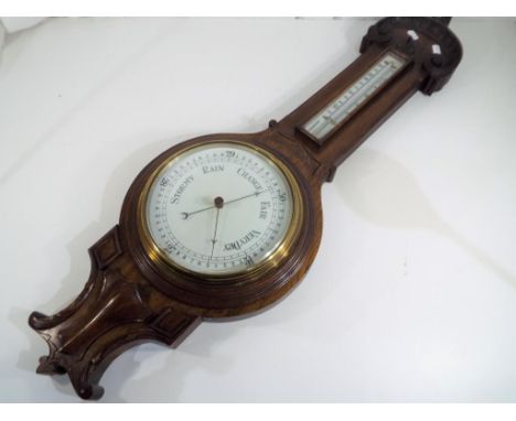 A carved oak wheel barometer / thermometer, 89 cm (high) - This lot MUST be paid for and collected, or delivery arranged, no 