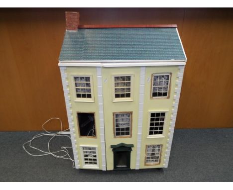 Dolls House - A three storey furnished dolls house of wooden construction, with a mix of wooden, ceramic, diecast metal furni