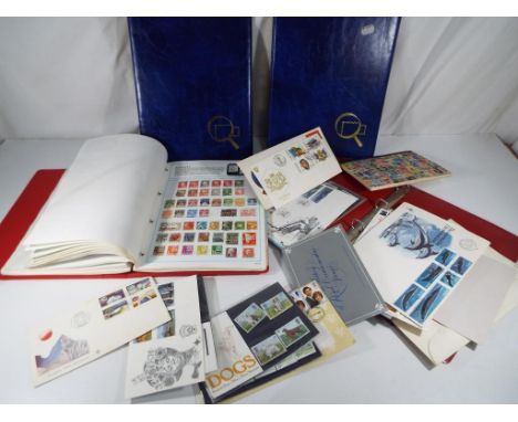 Two folders containing a collection of UK and worldwide postage stamps, a collection of loose mint stamps with a face value o
