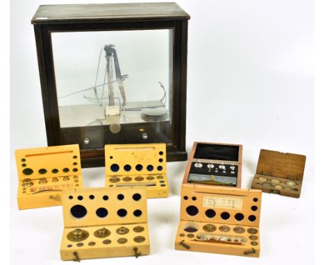 W A WEBB LTD; a cased set of scientific balance scales inset within wooden case, 37 x 35cm, together with a cased set of asso