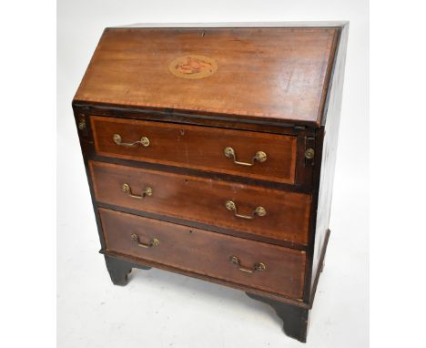 An Edwardian inlaid mahogany bureau, the fall front enclosing two drawers and fitted compartment above three drawers, raised 