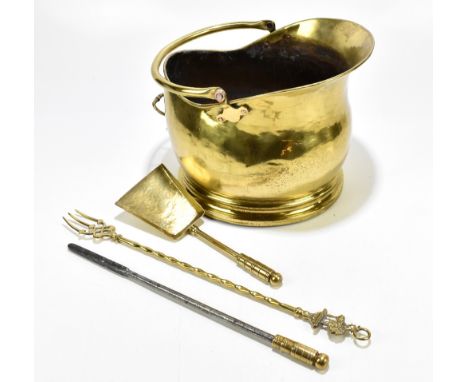 A late Victorian brass swing handled coal bucket and three brass handled fire tools (4).