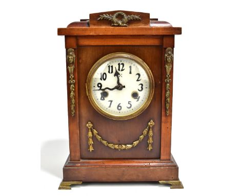 HAMBURG AMERIKANISCHE UHRENFABRIK; a late 19th century stained mahogany mantel clock, with applied gilt metal wreath and mask