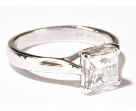 A platinum and diamond solitaire ring, the princess cut stone weighing approx 1.25ct in four claw swept mount, ring size I 1/