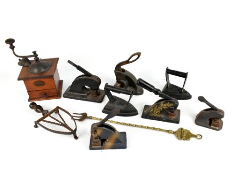 Five 19th century stamp presses of various size, together with a French coffee grinder, cast iron irons, etc.