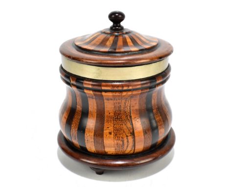 A treen lidded tobacco jar with silver plated collar of bombe outline, on three turned feet, height 15cm.Additional Informati