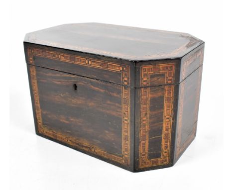 A Georgian coromandel tea caddy with inlaid parquetry cross banding, the hinged cover enclosing two compartments, length 19.5