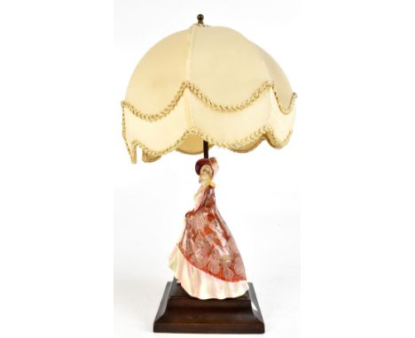 ROYAL DOULTON; a figural table lamp, HN1392 'The Paisley Shawl', raised on wooden plinth base, height including shade 47cm.Ad