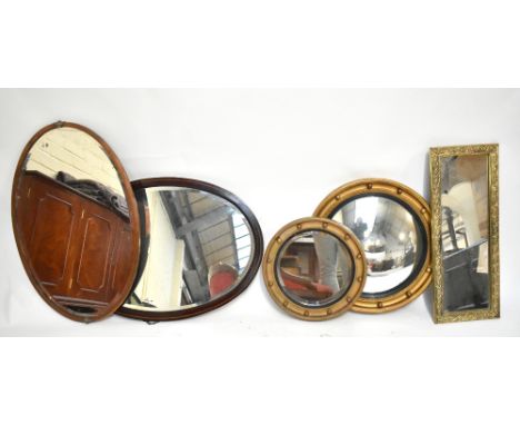 An Edwardian inlaid mahogany oval wall mirror with bevelled plate, length 80cm, together with a circular convex wall mirror, 