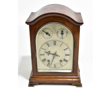 An Edwardian inlaid mahogany mantel clock, the silvered dial set with Roman numerals and two subsidiary dials, with Winterhal