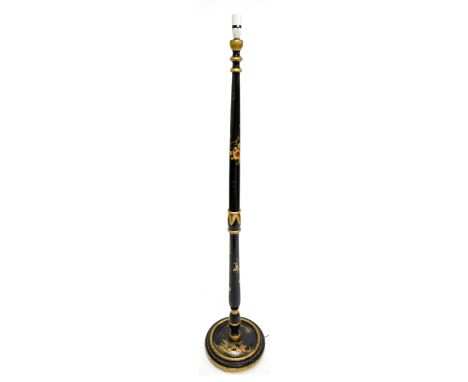 A decorative gilt heightened ebonised Chinoiserie standard lamp with floral detail to turned stem, on circular base featuring