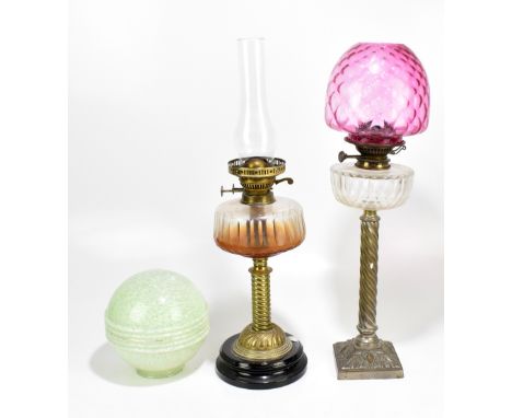 A Victorian brass oil lamp with clear glass reservoir, height including chimney 84cm, another oil lamp and associated Art Dec