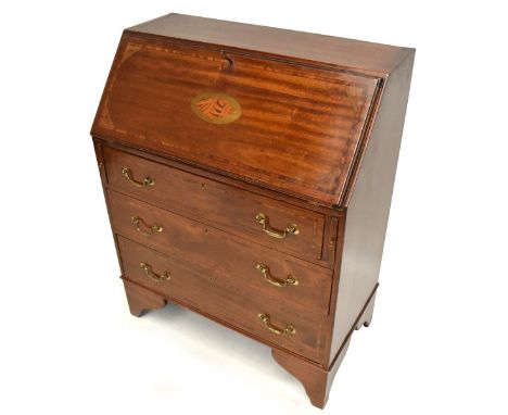 An Edwardian mahogany and inlaid bureau, the fall-front enclosing fitted interior above three drawers on bracket feet, height