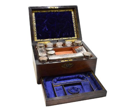 A Victorian rosewood travelling vanity set, the hinged cover with mother of pearl inlaid decoration enclosing an assortment o
