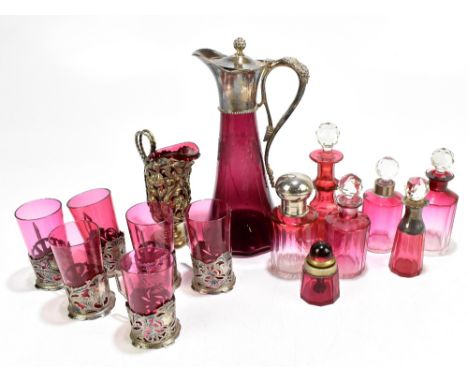 A collection of Victorian and later cranberry glassware, including six scent bottles, one example with white metal mount, a B