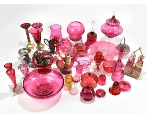 A large collection of Victorian and later cranberry glassware to include a four bottle condiment set raised on silver plated 