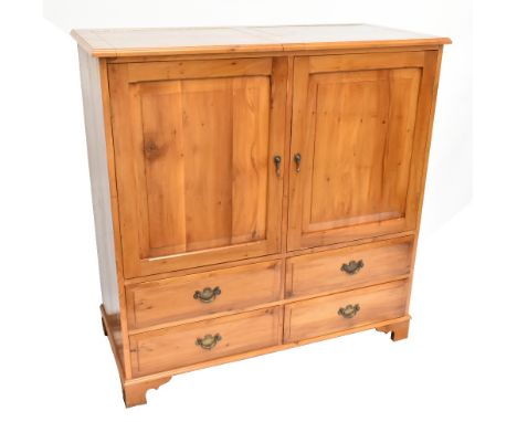 R J H RIMMEL CABINETMAKER OF ALDERLEY EDGE; a handmade yew wood cabinet with twin doors enclosing four adjustable shelves abo