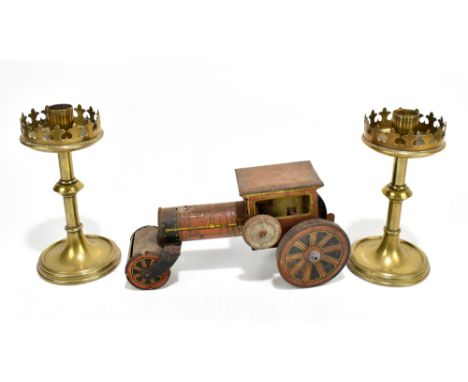 A pair of late 19th century Gothic Revival brass candlesticks, height 15cm, and a tinplate clockwork model of a traction engi