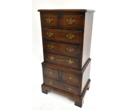 A small reproduction oak chest of eight drawers, raised on bracket feet, height 83cm, width 40cm, depth 29cm.&nbsp;Additional