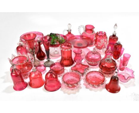 A large collection of Victorian and later cranberry glass, including claret jug, cake stand, numerous vases, two with base me