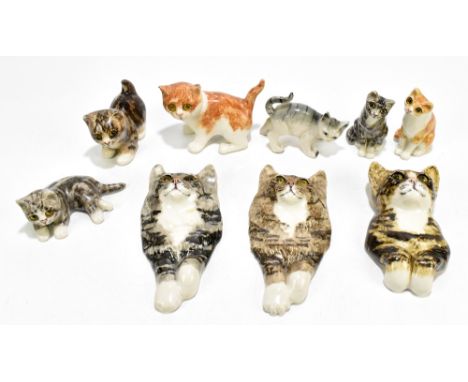 WINSTANLEY; five ceramic cats and three wall plaques in the form of cat busts, length of largest example 20cm.Additional Info