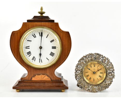 An Edwardian walnut and inlaid mantel time piece with white enamel dial, set with Roman numerals and raised on brass feet, he