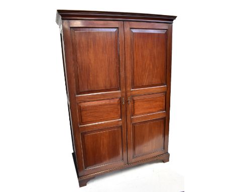 A late Victorian/Edwardian mahogany wardrobe with twin panelled doors, on bracket feet, height 183.5cm, width 125cm, depth 59