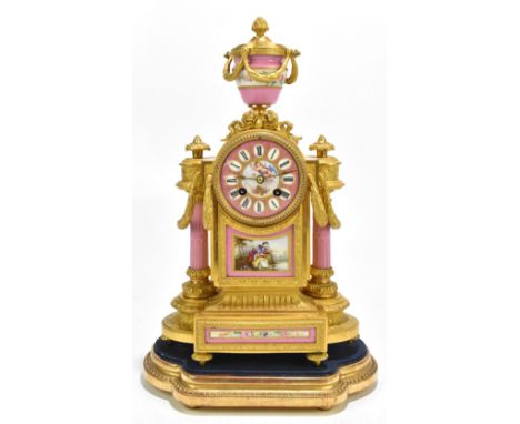 A 19th century French ormolu mantel clock with urn surmounts and hand painted porcelain panels and dial set with Roman numera