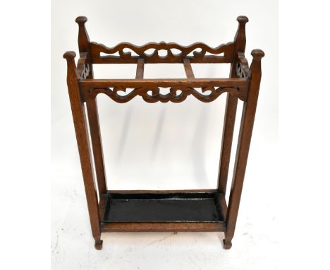 An early 20th century Arts &amp; Crafts oak stick stand with drip tray, height 85cm, width 55cm, depth 22cm.Additional Inform