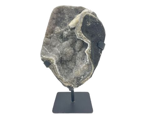 Smoky amethyst geode with a single calcite, upon a stand, H30cm