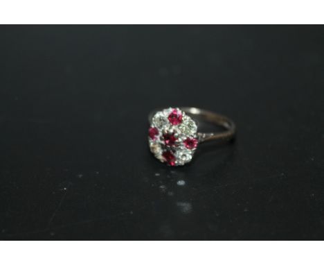 A HALLMARKED 18 CARAT WHITE GOLD RING, set with diamonds and ruby type stones, approx weight 4.7g, ring size P