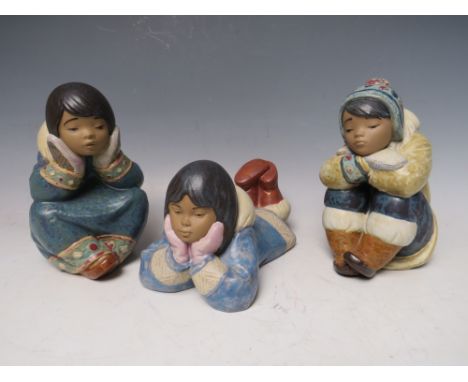 TWO LLADRO SPANISH POTTERY FIGURES, comprising 'Pensive Eskimo Boy' and 'Pensive Eskimo Girl', together with a similar Nao fi