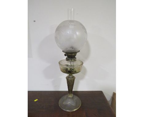 A LATE 19TH CENTURY OIL LAMP, the plated base leading to an etched clear glass reservoir, with etched shade and chimney