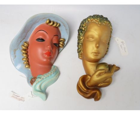 A GOLDSCHEIDER POTTERY WALL MASK, modelled as a woman in a hat with turquoise hair swept to one side, H 21.5 cm, marked to th