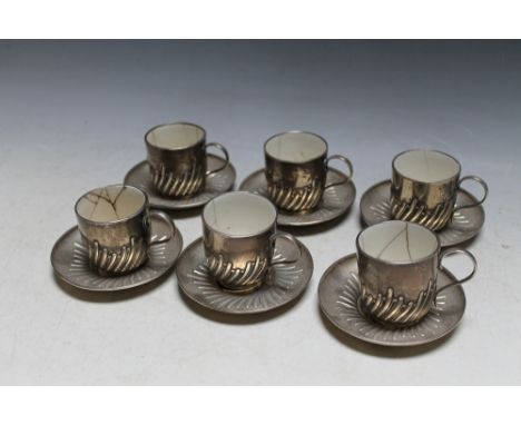 A SET OF SIX HALLMARKED SILVER COFFEE CUPS AND SAUCERS BY WILLIAM HUTTON &amp; SONS LTD - LONDON 1905, all cups have badly cr