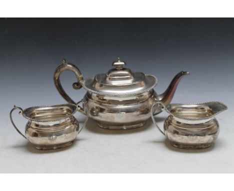 A HALLMARKED SILVER THREE PIECE TEA SERVICE BY HARRISON BROTHERS AN HOWSON - SHEFFIELD 1946, with thistle crest to each piece