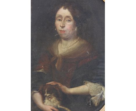 CIRCLE OF ARNOLD BOONEN (1669-1729). Portrait of a lady seated holding a dog, half-length, oil on canvas, oval, 85 x 67.5 cm
